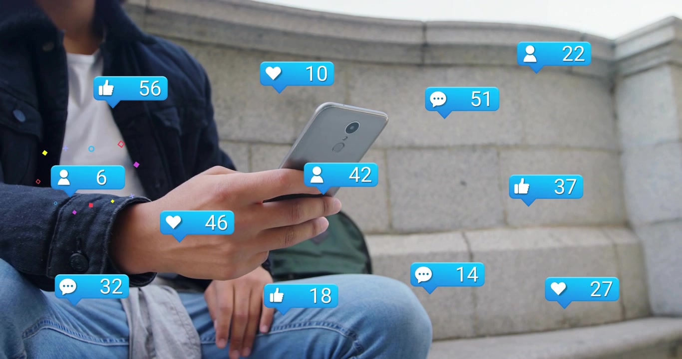 Man sitting steps with phone scrolling and sparking social media icons filling shot showing growth