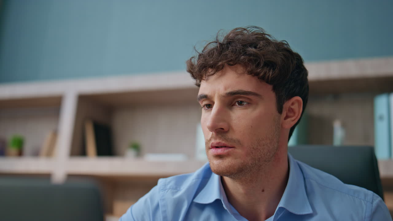 Angry guy reacting news in agency closeup. Emotional nervous businessman reading