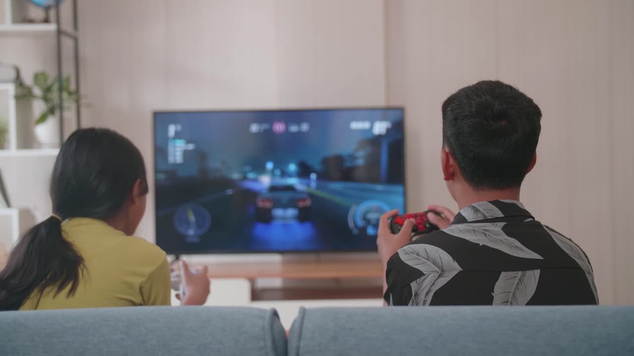 Back View Of Children Play Racing Video Games On Tv