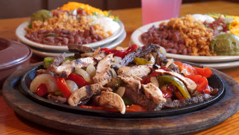 sizzling beef and chicken fajita combo platter with sides, close up slider slow motion 4k