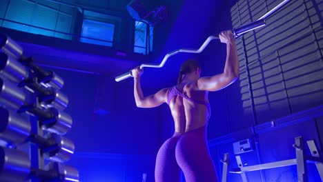 woman lifting barbell in a gym