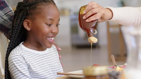 Happy-african-american-parents-and-daughter-having-breakfast-at-home,-slow-motion