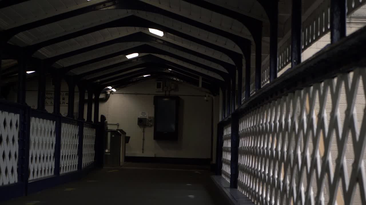 Walking along lonely empty railway bridge wide shot