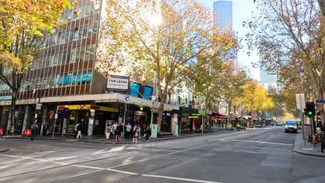 a tram moves through a busy city intersection