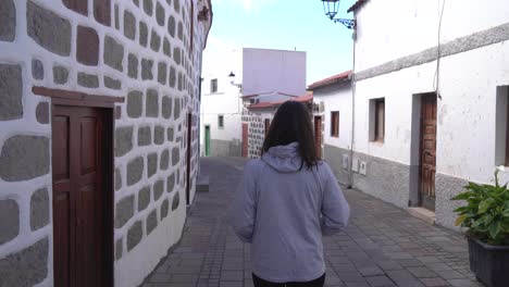 woman walking through tejeda town in gran canaria