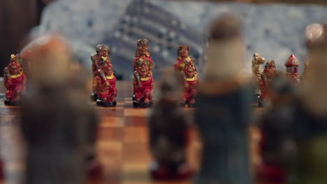 low orbit pan of intense chess match between natives and colonialist-themed pieces in ecuador, shallow depth of field