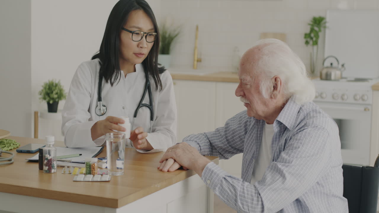 Doctor giving medication to elderly patient at home