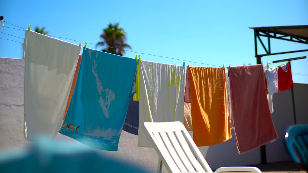 Beach Colourful Towels Waving On Wind Hung Up To Dry Outside