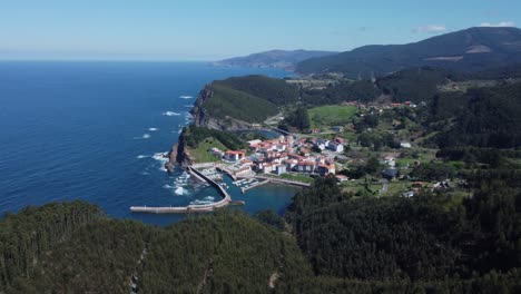 Biscay-coastal-Basque-village-port-of-Armintza,-rotating-aerial-view