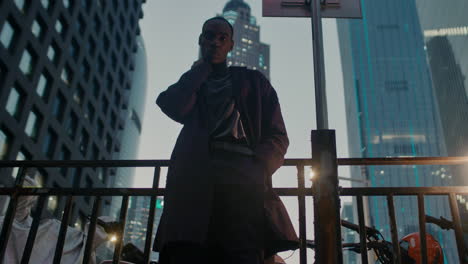 stylish man in a cityscape at dusk