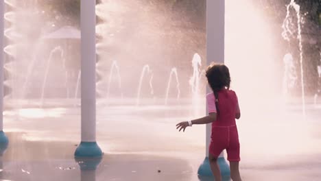 little-girl-runs-in-fountain-jets-in-aquapark-slow-motion
