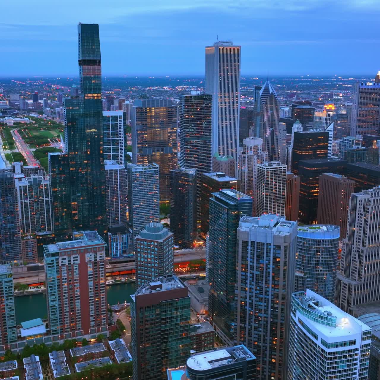 Chicago scenic view in the twilight. Grand skyscrapers full of lights. Metropolis panorama from aerial view