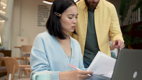 an business woman showing documents to a partner at a meeting in a coffe shop