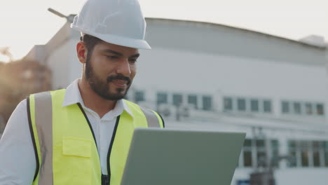 engineer working on a laptop on a construction site
