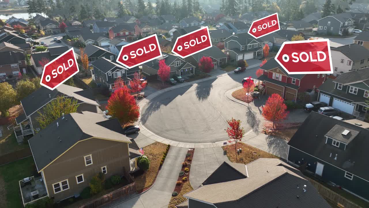 Orbiting shot of an American neighborhood with &amp;quot;SOLD&amp;quot; signs animating over the houses