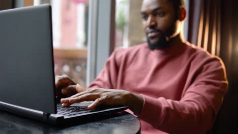 man working with the laptop in the restaurant. freelance work from cafe