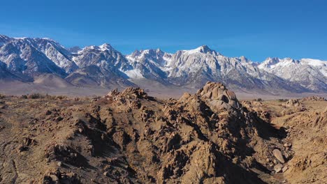 A-traveling-aerial-shot-reveals-the-snow-capped-Eastern-Sierra-Nevada-mountains-and-Mount-Whitney-in-snow-winter-near-Lone-Pine-California-1