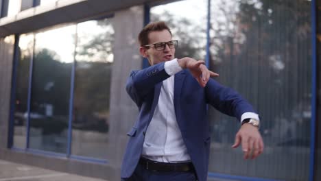 successful businessman dancing crazy happy funky dancing. caucasian street dancer freestyle in the city, celebrating his project