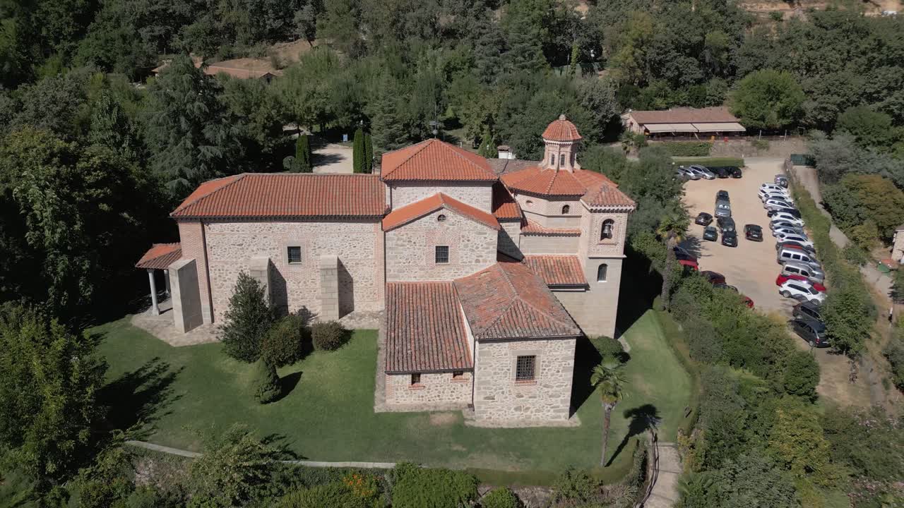 Reverse and upward flight with drone in the majestic sanctuary of the Virgin of Chilla, 16th century, we see its rear structure and its variety of roofs, it is surrounded by gardens, it is fascinating