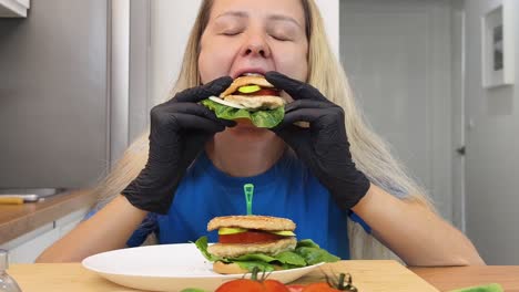 woman eating homemade burgers