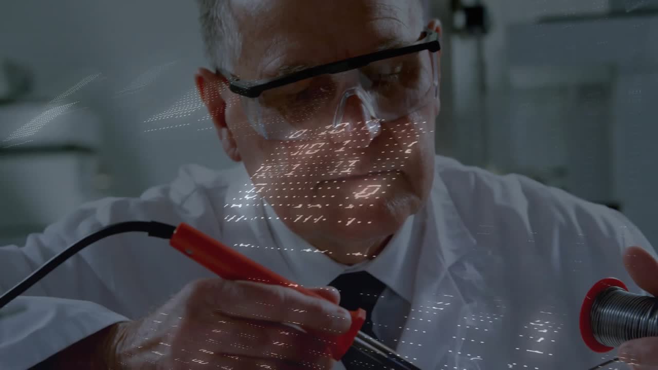 Technician picking red probe and feeding wire over electronics board while grid visualizing flow