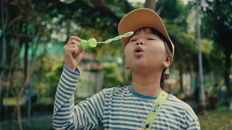 smiling child blowing bubbles in a park on a sunny day, joyful and carefree vibe