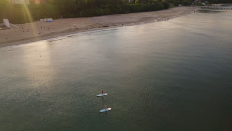 a romantic date at the beach doing an outdoor activity using sup boards