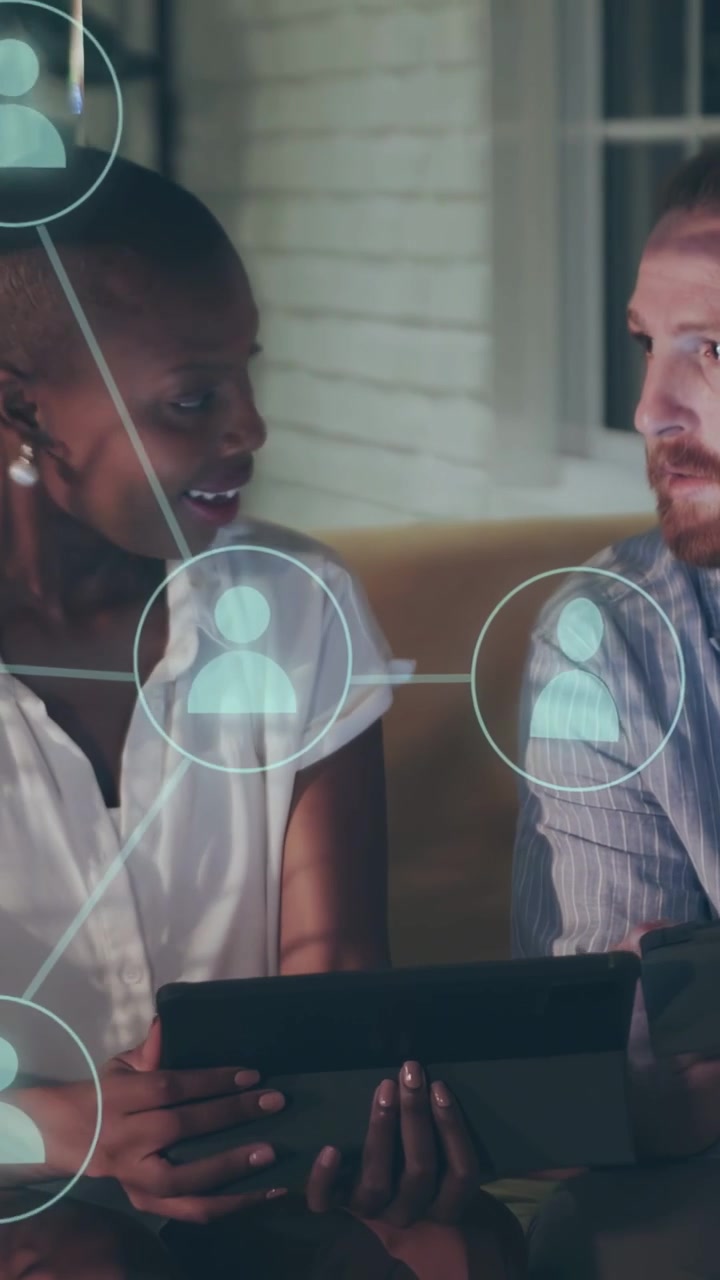Vertical video: Woman holding tablet, man tapping, starting binary node overlays aiding tech team