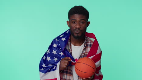 bearded young man basketball fan holding american usa flag doing winner gesture, dancing alone