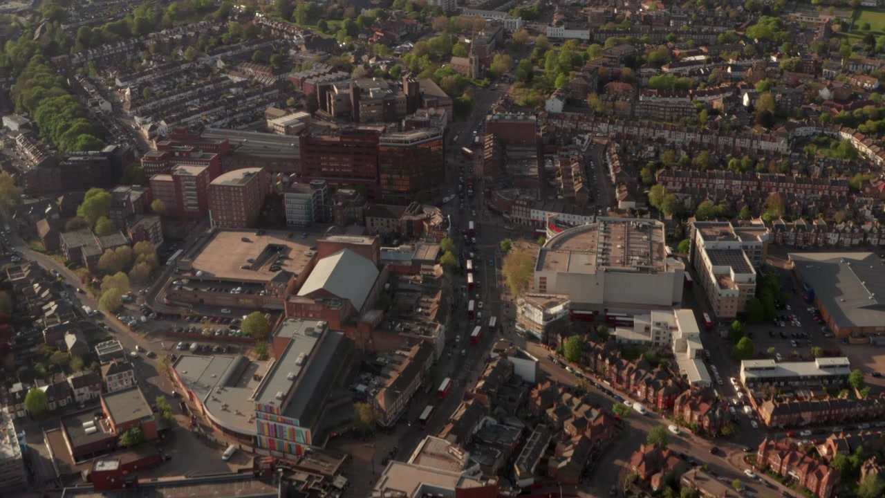 Aerial shot over north wood green high street towards st Michael's church