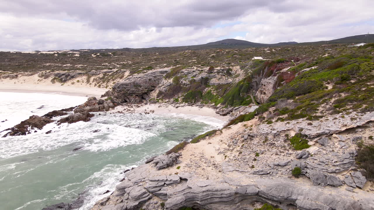 Limestone coastal cliffs with historic Klipgat Cave in Walker Bay reserve, drone