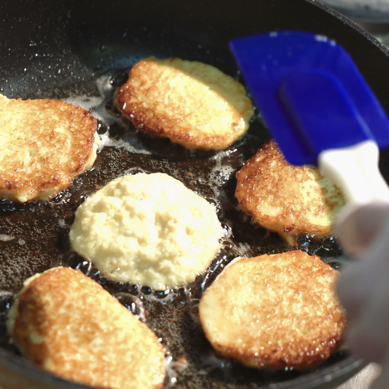 Preparation of golden crispy potato pancakes in a frying pan. Vegetable fritters. Sqare video