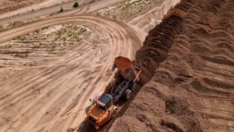 Dump-Truck-Unloading-Material-at-Gravel-Pit-in-Bluffdale-Utah---Aerial-Orbit