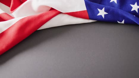 close up of national flag of usa on gray background with copy space