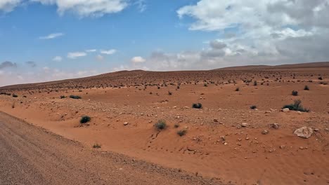 Traveling-while-driving-on-Tunisia-desert-road,-car-driver-POV