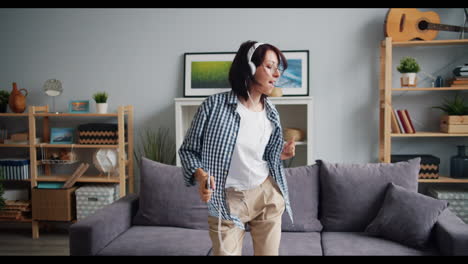 woman dancing to music at home