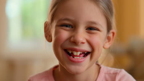 close-up portrait of a happy, laughing young girl