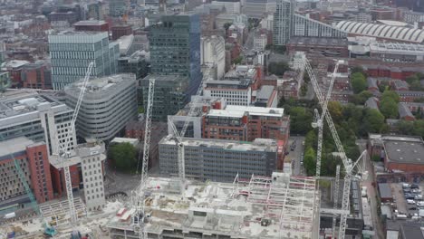 drone shot orbiting construction cranes 07