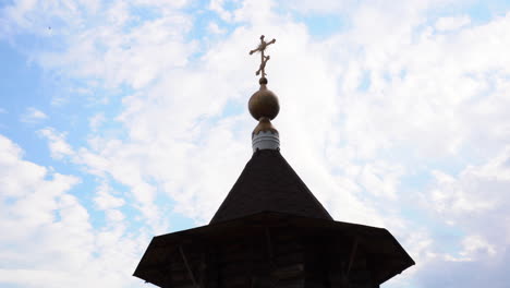wooden church tower with cross and dome