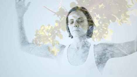 animation of glowing light over woman practicing yoga against trees in background