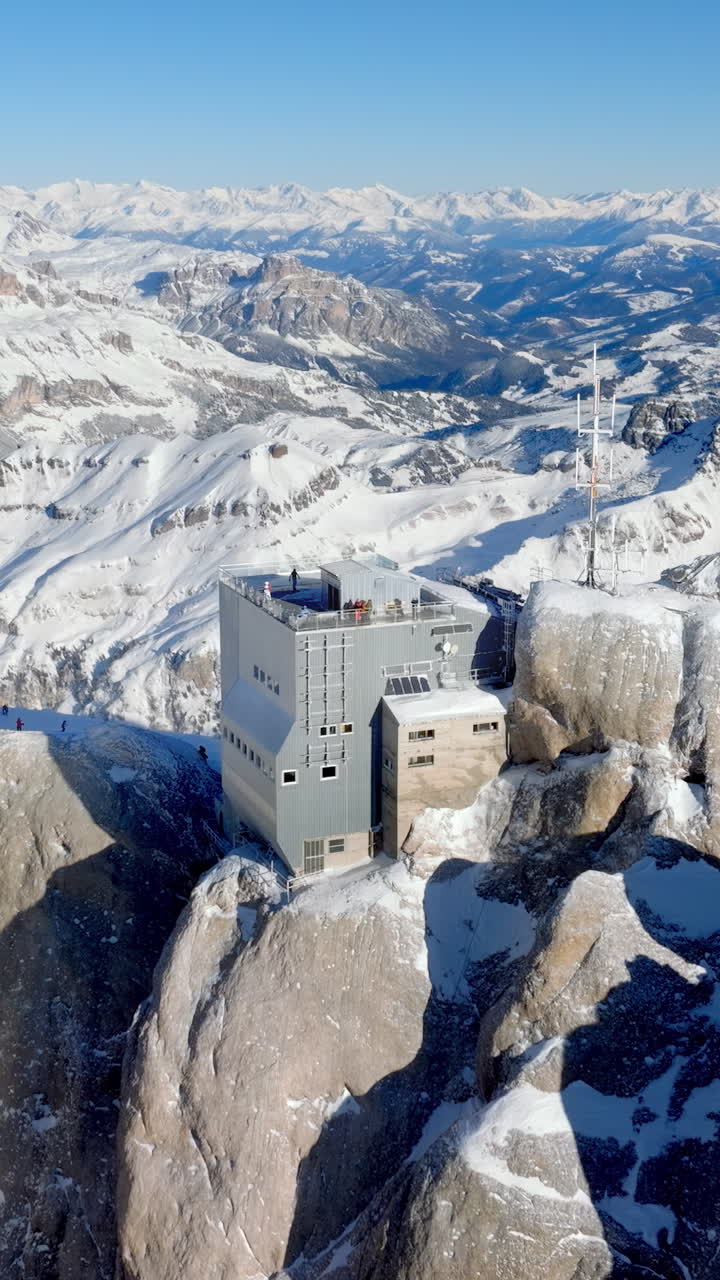 Aerial drone view of the Marmolada mountain in the Dolomites, northeastern Italy with the blue sky on the background. Vertical