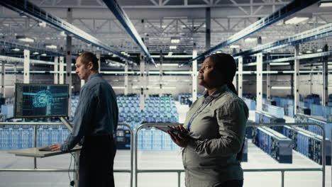 software developers monitor server hub activity using tablet