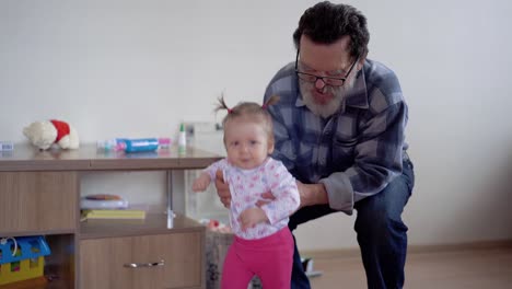 abuelo con barba y gafas jugando con una pequeña nieta adorable 3