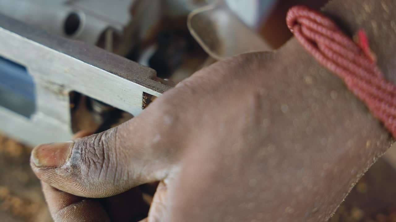 Hand positioning for precise carpentry task. Focused hand arrangement preparing for accurate cut. Carefully adjusted hand positioning and equipment readiness for meticulous woodworking accuracy