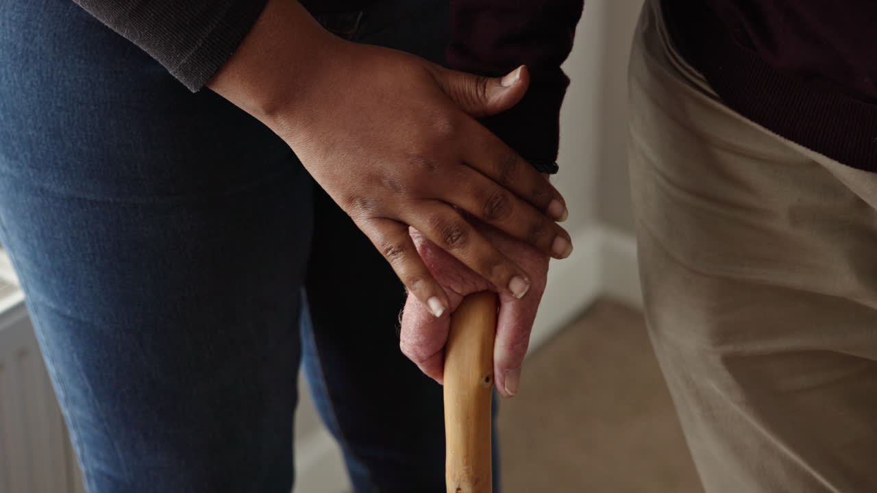 Interracial Couple Holding Hands with Walking Stick