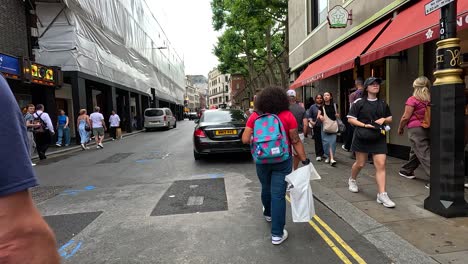 people walking on a bustling london street