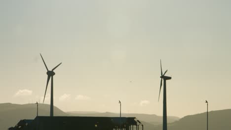 Wind-Turbines-Spinning-with-Incredible-Sunrise-Lighting-and-Hazy-Background-4K