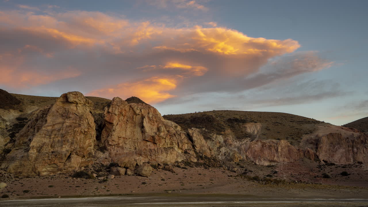 Sunset Timelapse Over Patagonian Desert. Moving Clouds Above Rocky Landscape