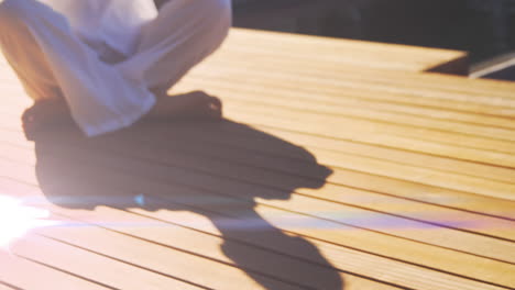 animation of light spots over caucasian woman practicing yoga and meditating