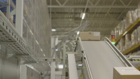 packages move on a conveyor belt in a modern warehouse